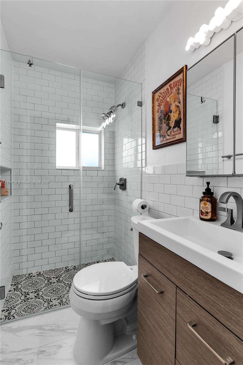 20130 Southwest 106th Court Cutler Bay, FL 33189 - Photo 13 of 42 a bathroom with a sink a toilet and shower