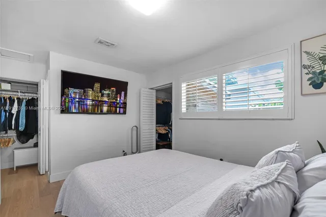 a bedroom with a bed and a wall painting