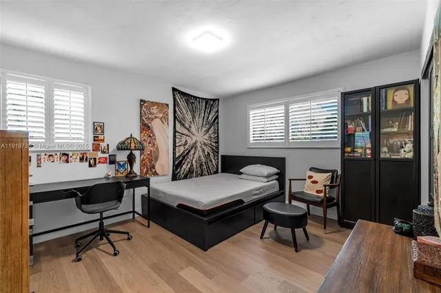 a living room with furniture a rug and a window