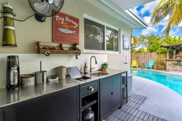 a kitchen with stainless steel appliances a sink a stove and a wooden floor