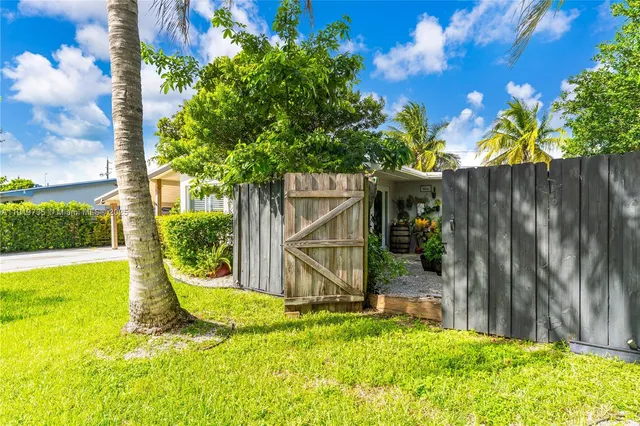 a view of a backyard with a tree