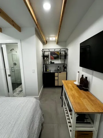 a view of a patio with table and chairs and potted plants