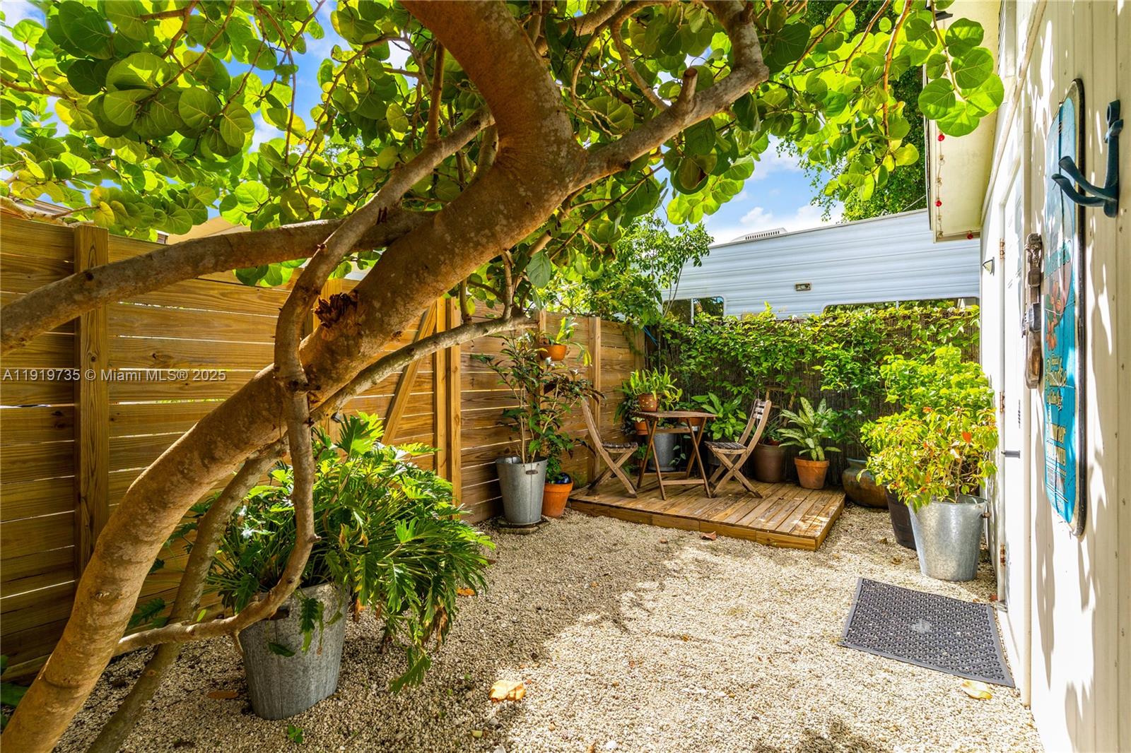 20130 Southwest 106th Court Cutler Bay, FL 33189 - Photo 38 of 42 a view of a patio with table and chairs and potted plants