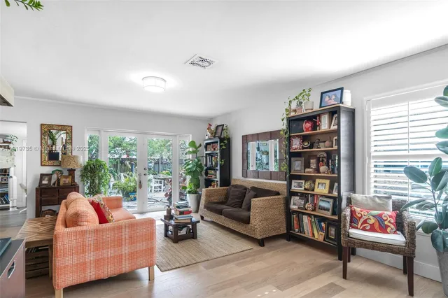 a living room with furniture and a book shelf