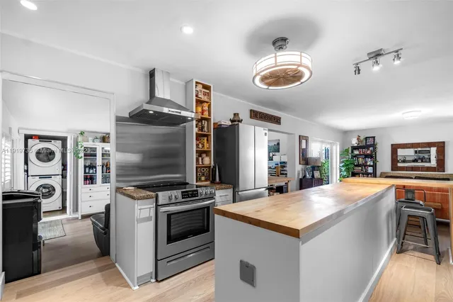 a kitchen with stainless steel appliances granite countertop a stove and a refrigerator