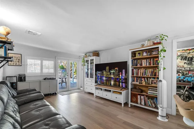 a living room with furniture and a book shelf