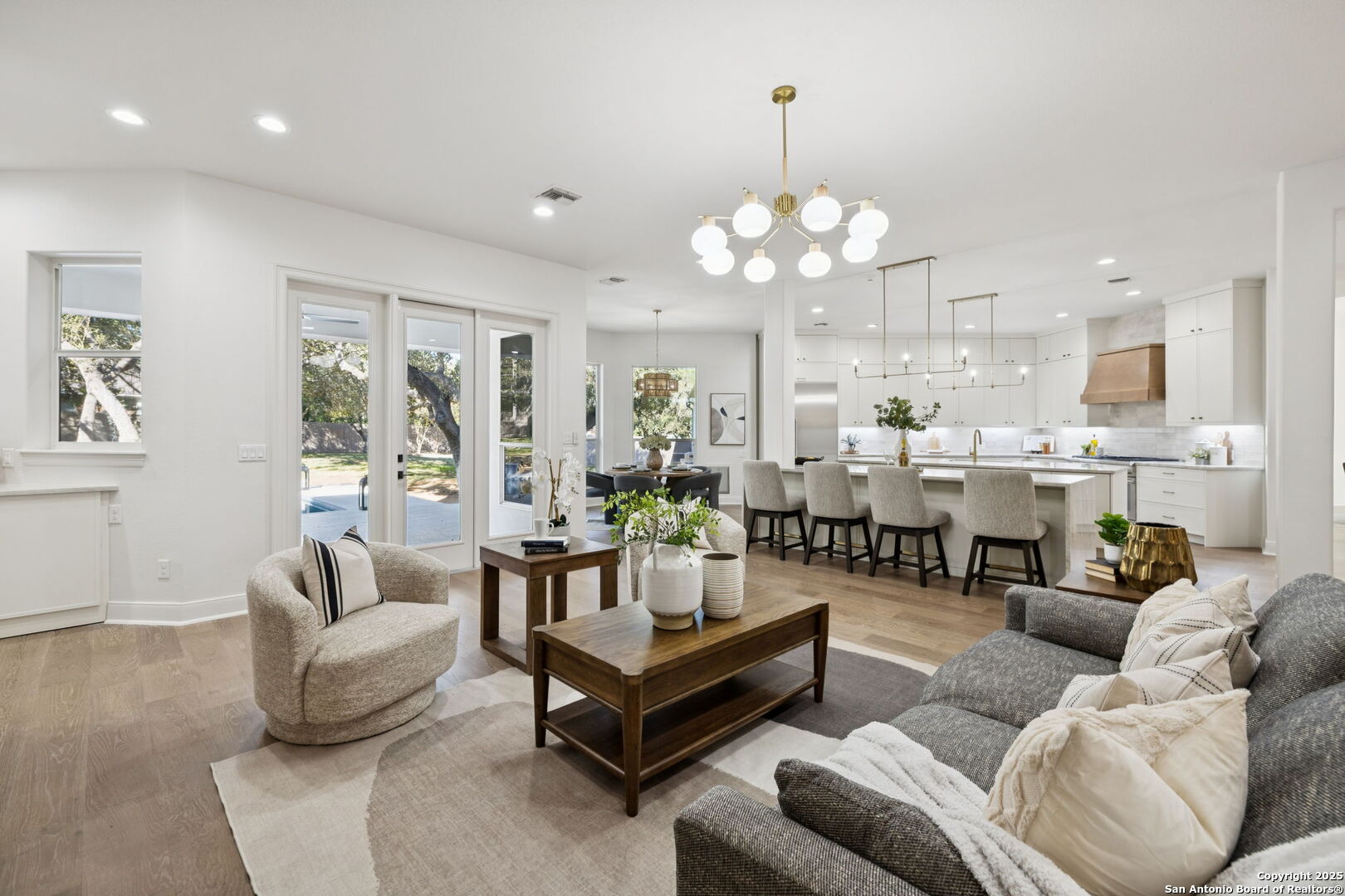 207 Box Oak Shavano Park, TX 78230 - Photo 13 of 50 a living room with furniture kitchen view and a chandelier