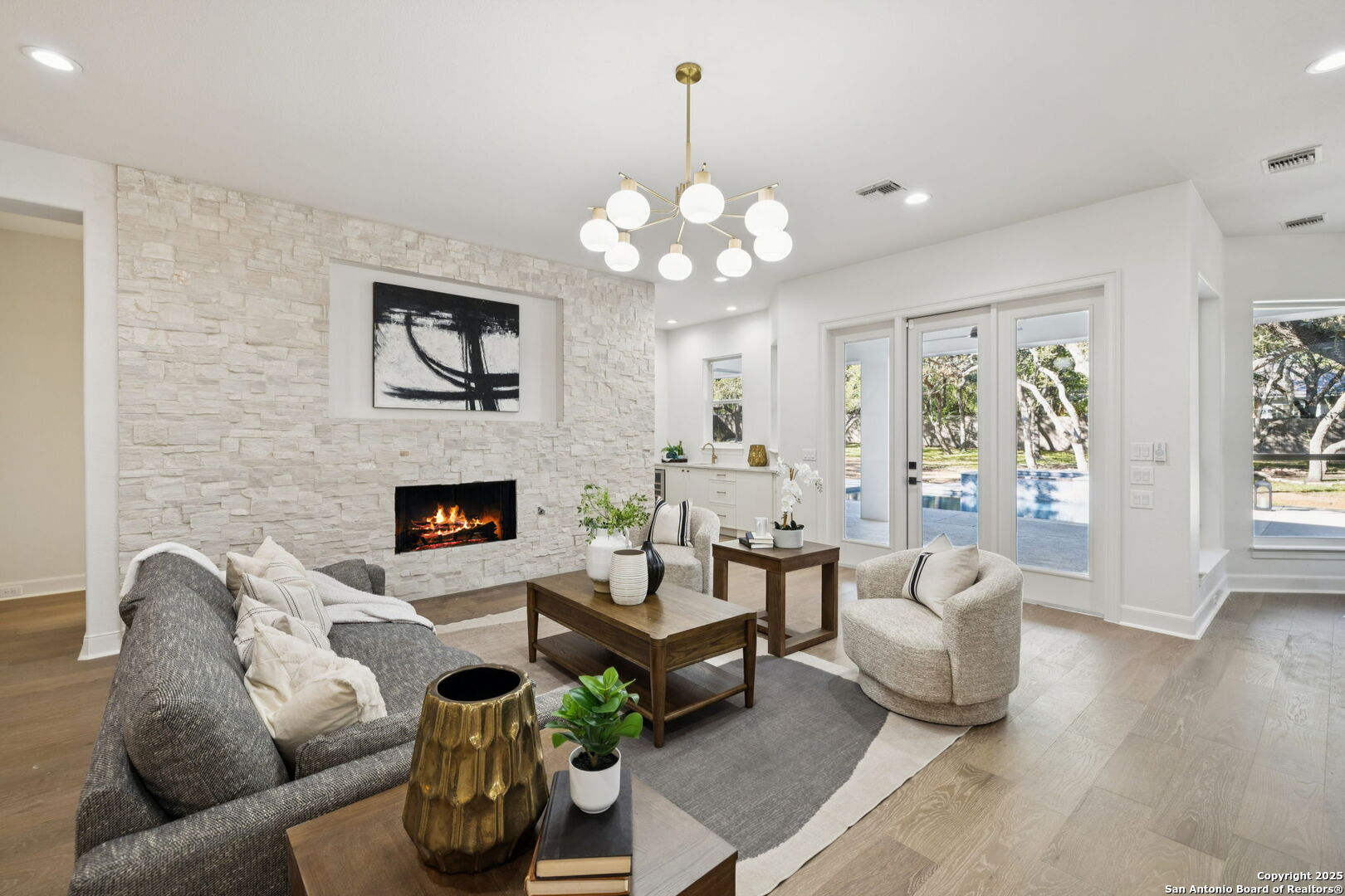 207 Box Oak Shavano Park, TX 78230 - Photo 22 of 50 a living room with furniture a fireplace and a chandelier