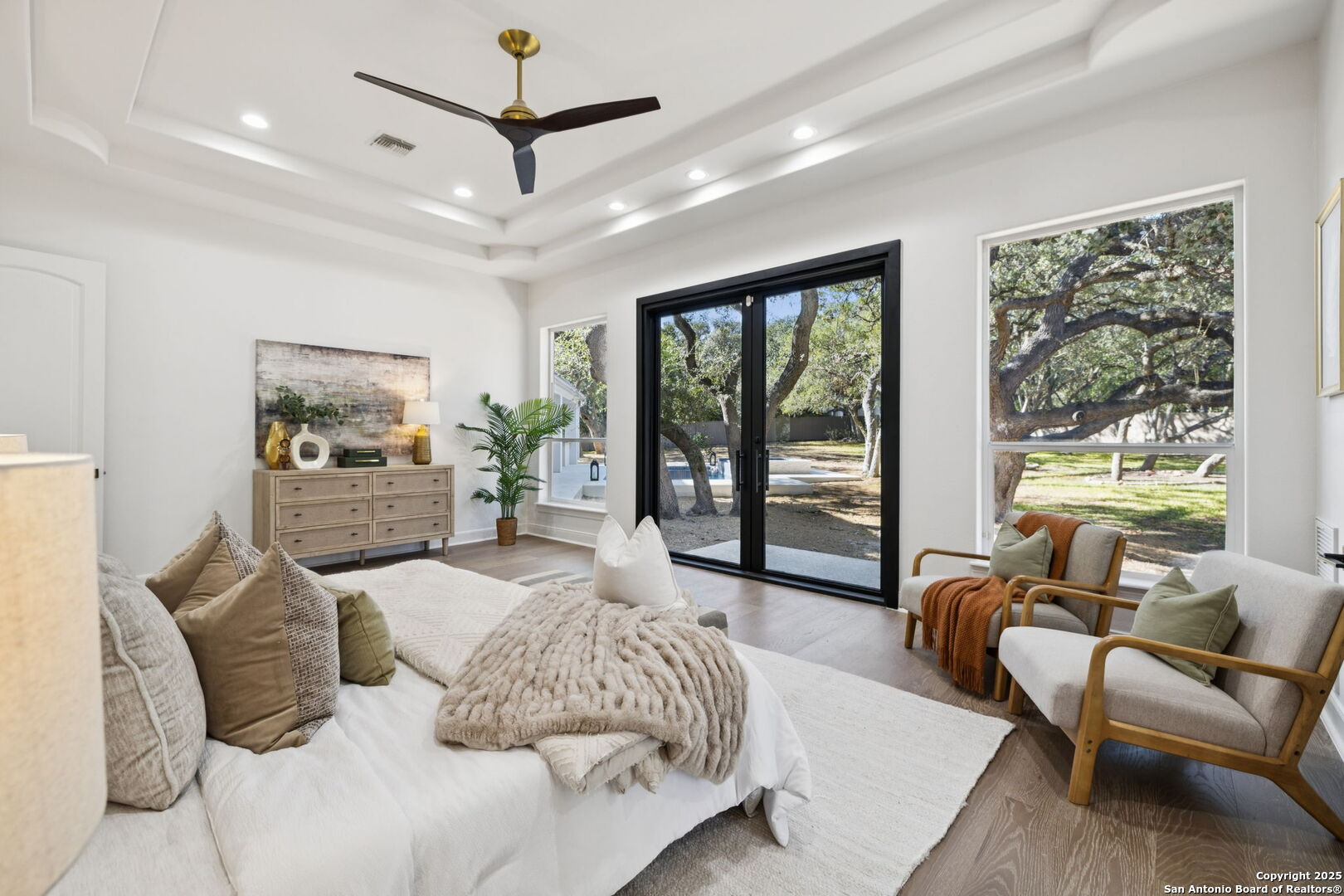 207 Box Oak Shavano Park, TX 78230 - Photo 28 of 50 a spacious bedroom with a bed a couch and a large window