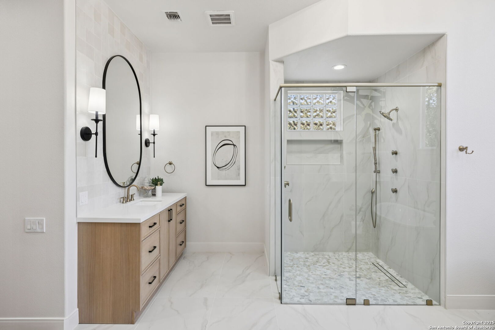 207 Box Oak Shavano Park, TX 78230 - Photo 34 of 50 a bathroom with a mirror a sink and a shower