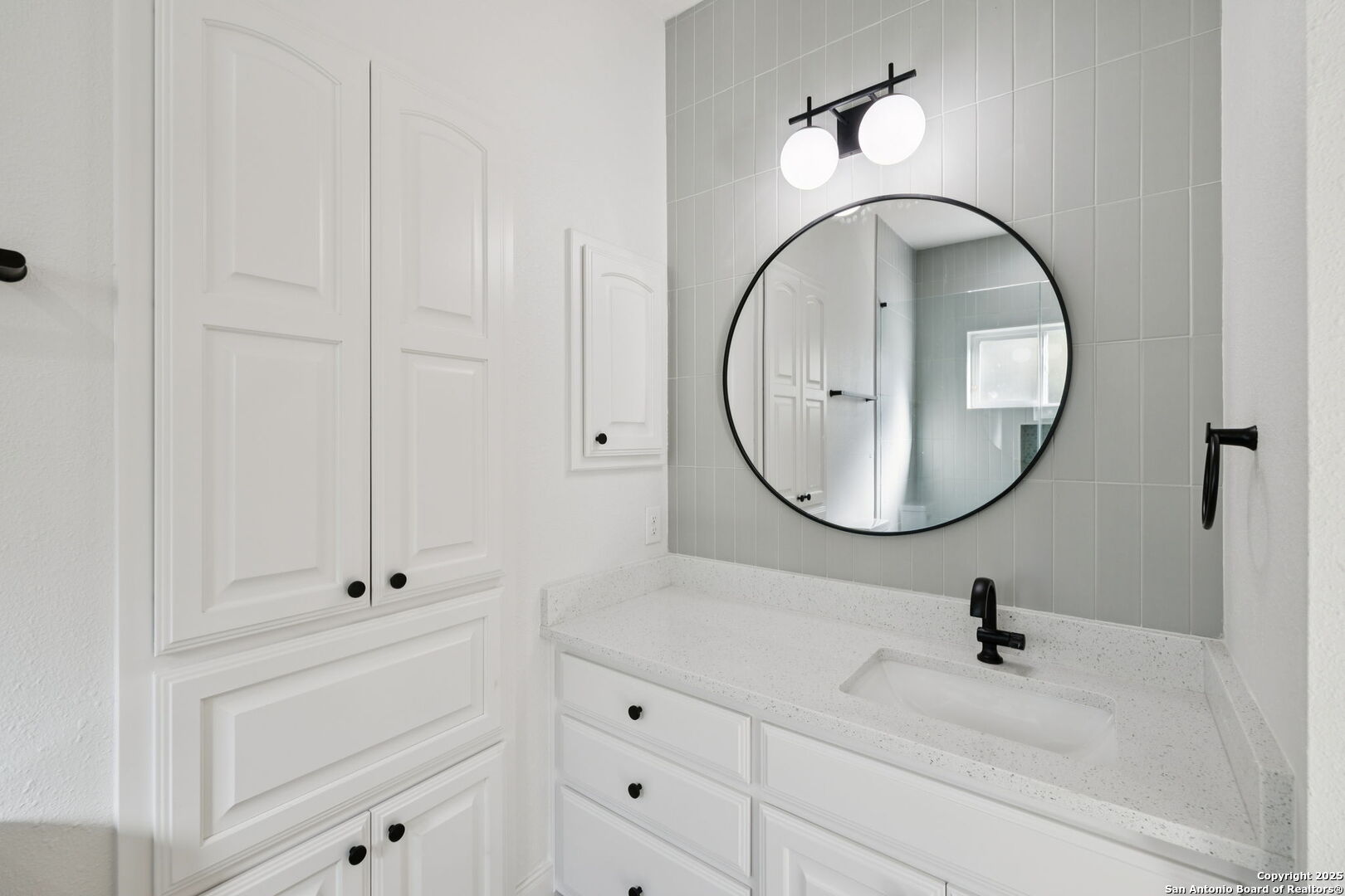 207 Box Oak Shavano Park, TX 78230 - Photo 44 of 50 a bathroom with a sink vanity and a mirror