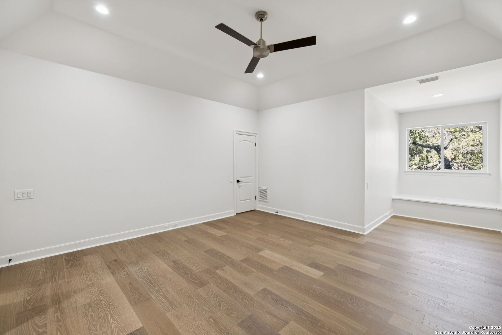 207 Box Oak Shavano Park, TX 78230 - Photo 45 of 50 an empty room with wooden floor and ceiling fan