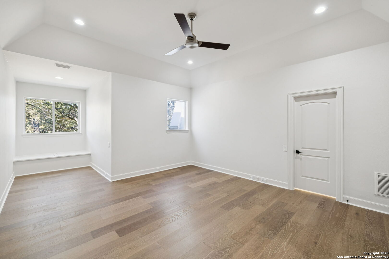 207 Box Oak Shavano Park, TX 78230 - Photo 47 of 50 wooden floor in an empty room with a window