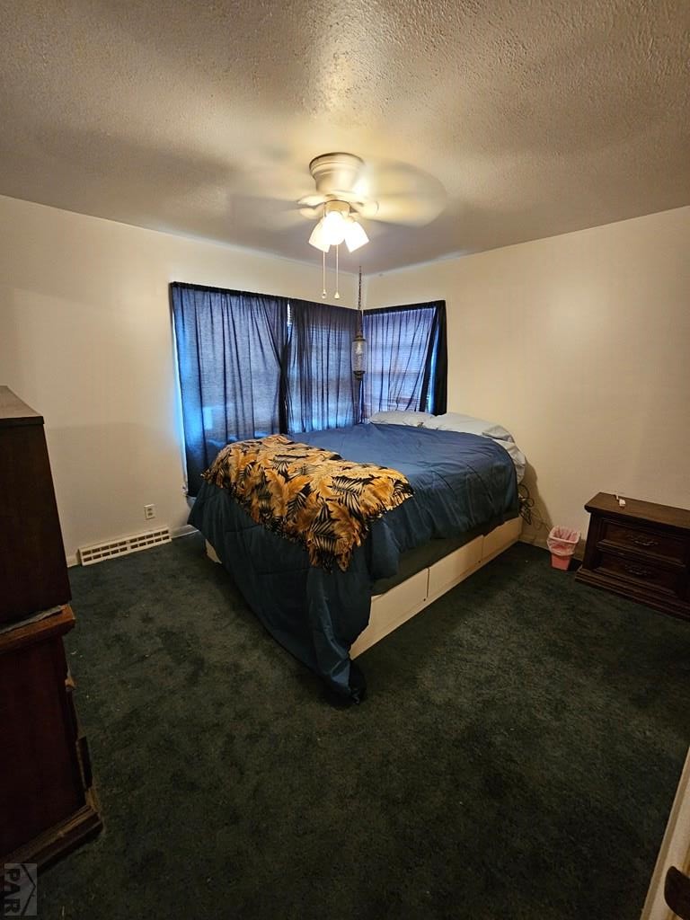900 Rittgers Street Eads, CO 81036 - Photo 19 of 31 a bedroom with a bed and a chandelier
