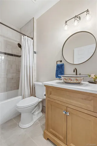 a bathroom with a toilet a sink and a mirror