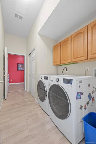 a utility room with sink dryer and washer
