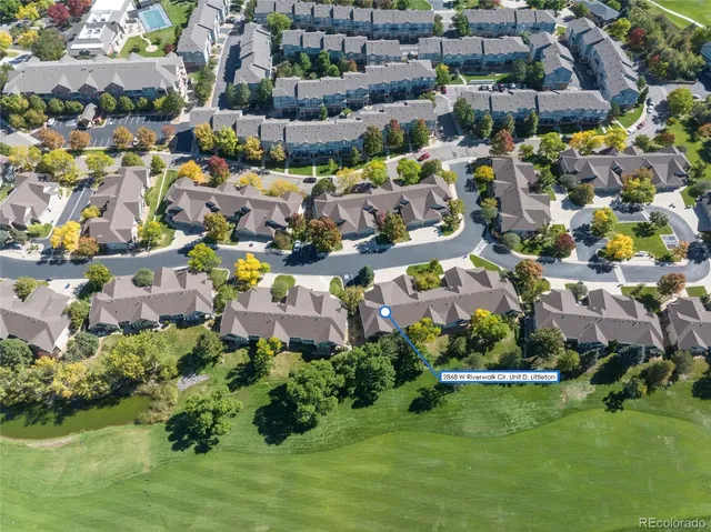 an aerial view of residential houses with outdoor space and swimming pool
