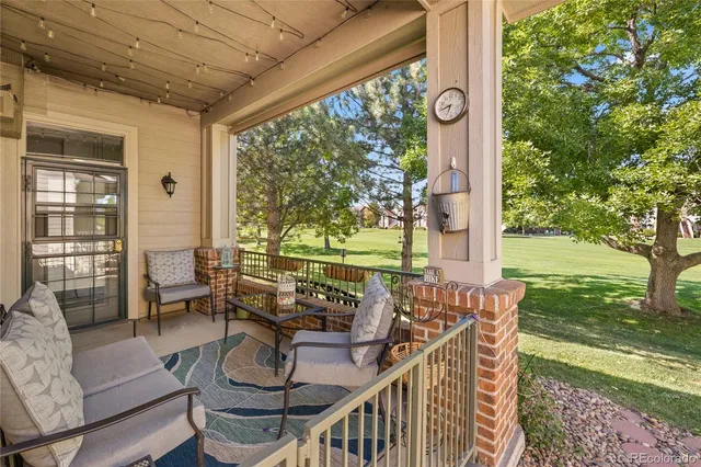 a view of an outdoor dining space with furniture and garden view
