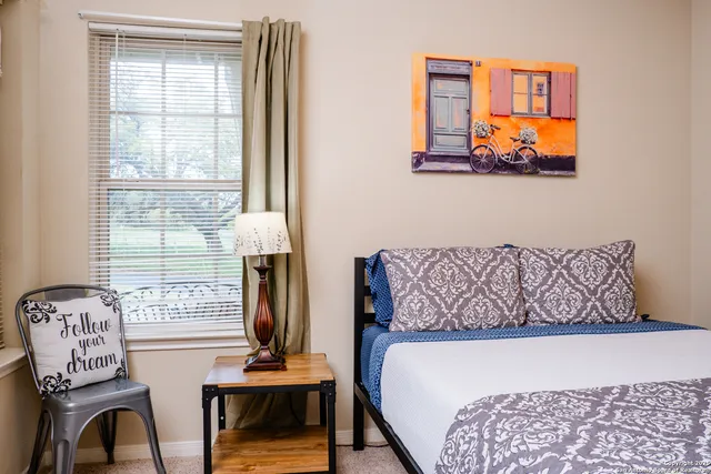 a bedroom with furniture and a window