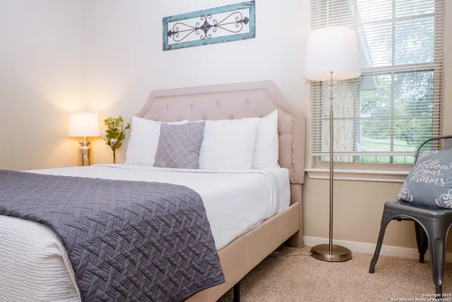 a bedroom with a bed and a window