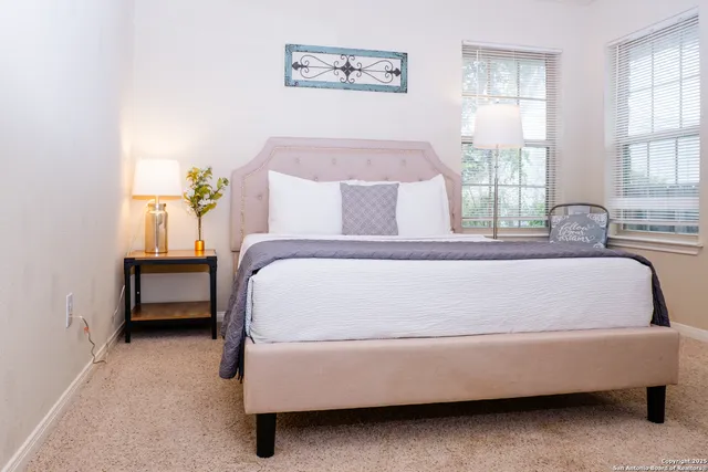a bed sitting in a bedroom next to a window