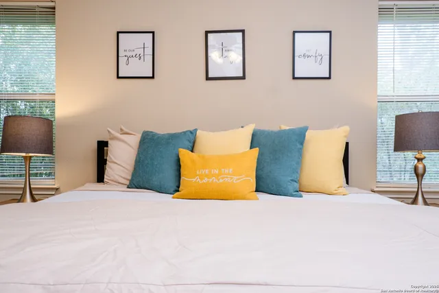 a bedroom with a bed and lamp with window