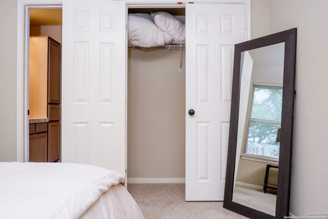 a bedroom with a bed and a mirror