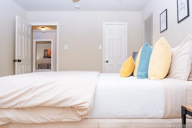 a bedroom with a bed and a mirror