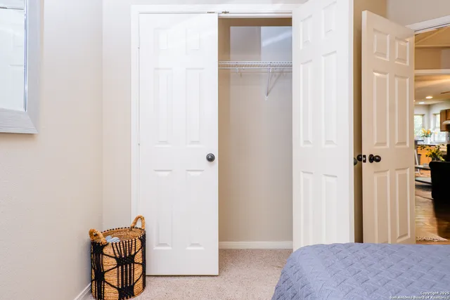 a living room with furniture kitchen view and a chandelier