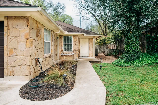 a backyard of a house with table and chairs