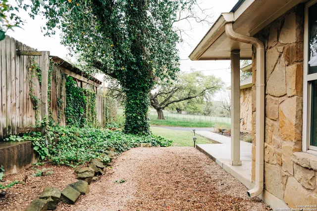 a living room with furniture a chandelier and a flat screen tv