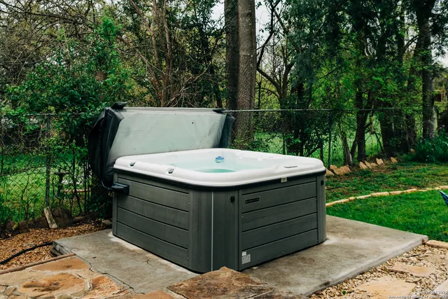 a dining room with furniture a chandelier and wooden floor