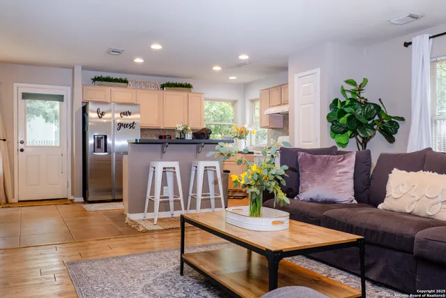 a living room with stainless steel appliances kitchen island granite countertop furniture and a view of kitchen