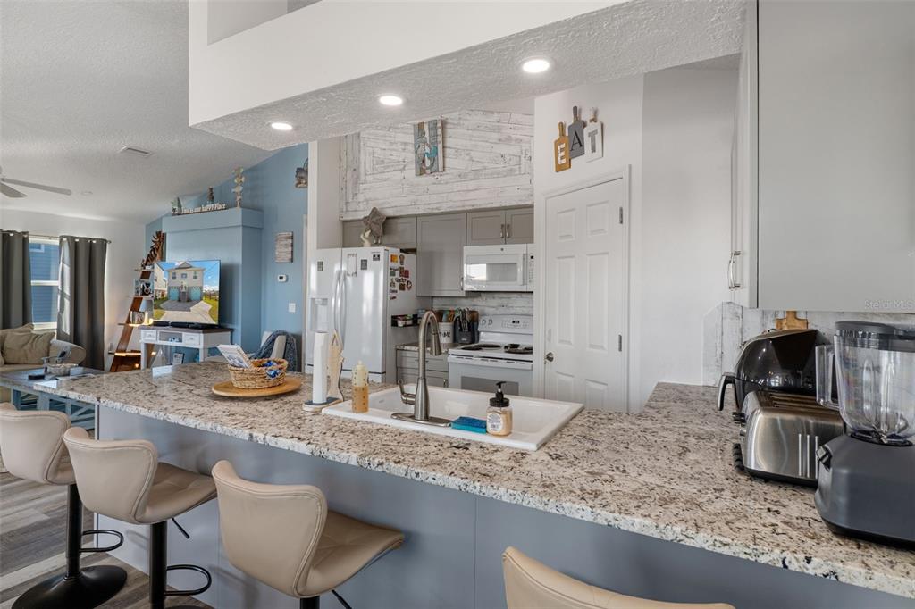 4046 Casa Court Hernando Beach, FL 34607 - Photo 13 of 58 a kitchen with stainless steel appliances granite countertop a sink refrigerator and cabinets