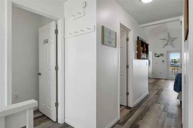 a bedroom with a large bed and a flat tv screen on dresser