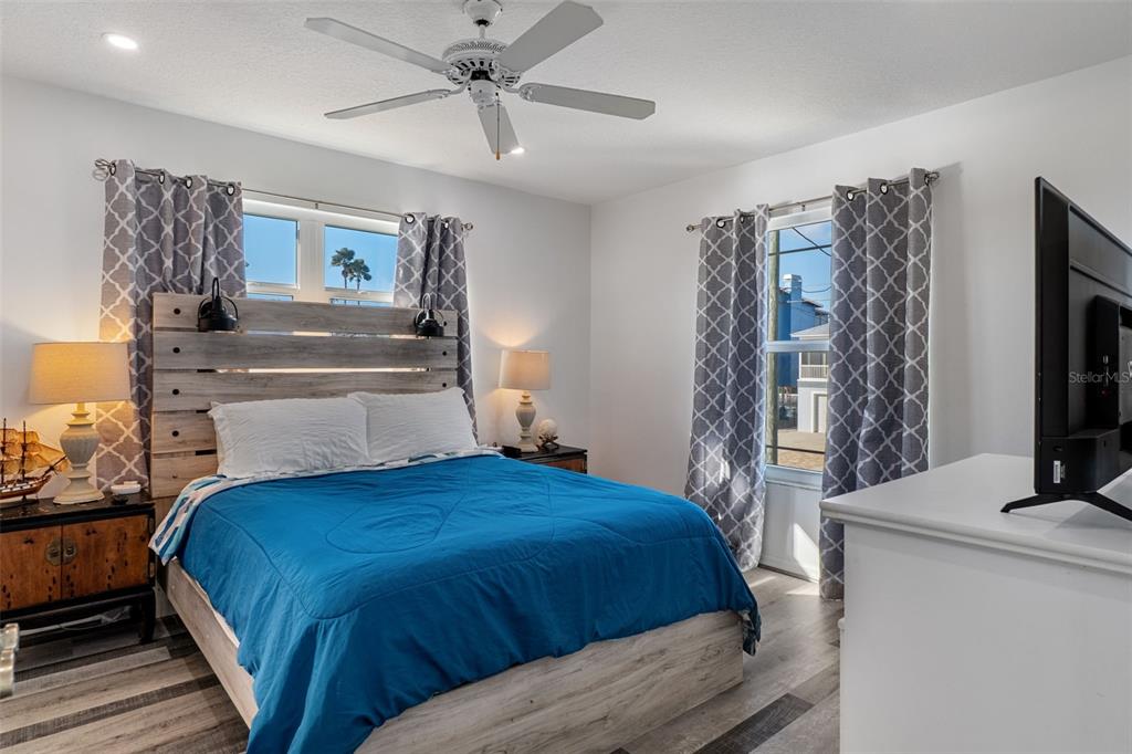 4046 Casa Court Hernando Beach, FL 34607 - Photo 18 of 58 a bedroom with a large bed and a flat tv screen on dresser