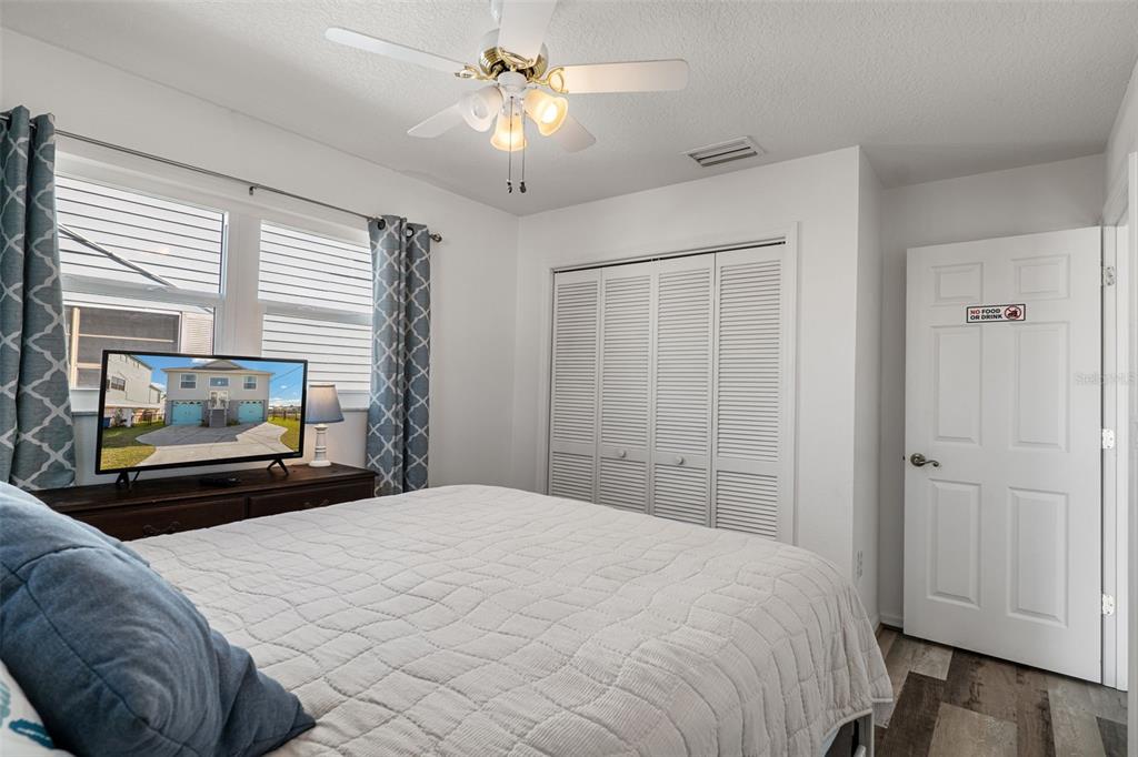 4046 Casa Court Hernando Beach, FL 34607 - Photo 24 of 58 a bedroom with a bed and a chandelier