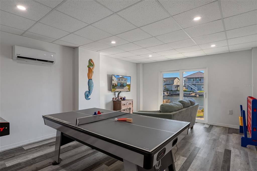 4046 Casa Court Hernando Beach, FL 34607 - Photo 30 of 58 a living room with furniture a flat screen tv and a table