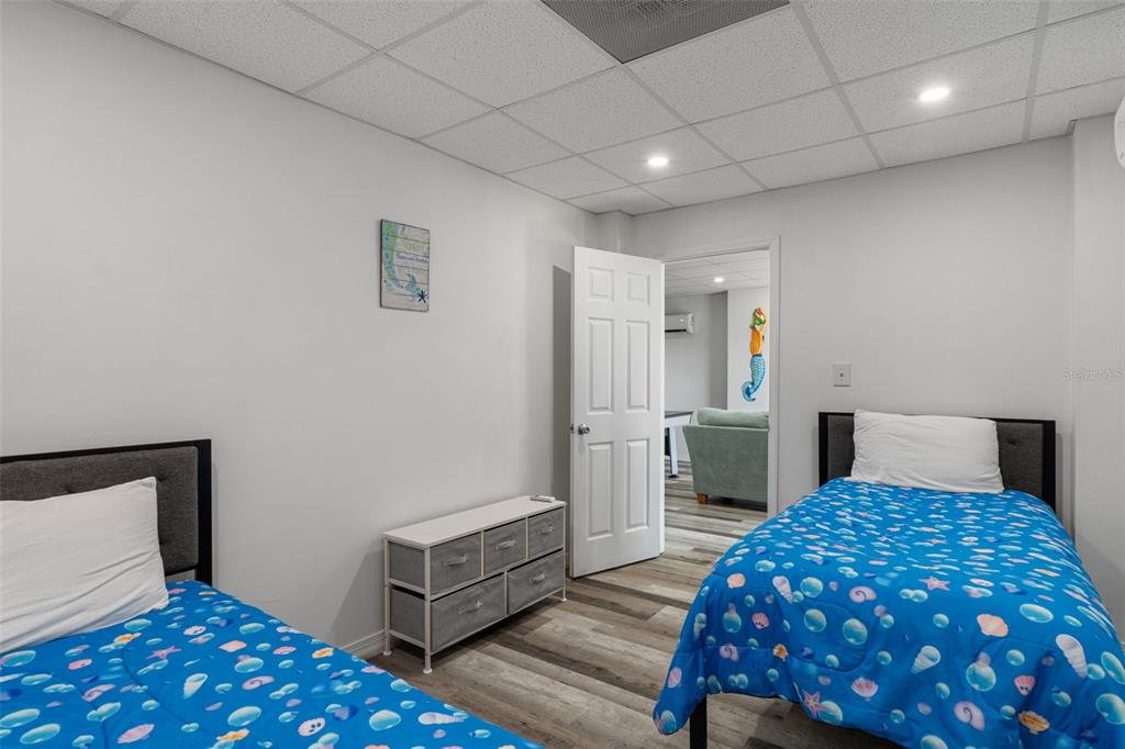 4046 Casa Court Hernando Beach, FL 34607 - Photo 37 of 58 a bedroom with a large bed and a chair