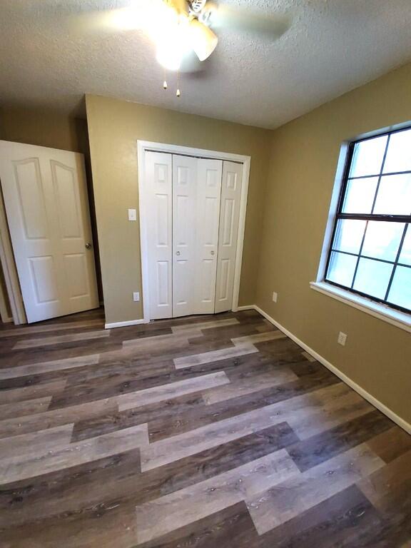 6508 25th Street Lubbock, TX 79407 - Photo 13 of 14 a view of an empty room with wooden floor and a window