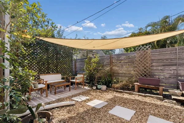 an aerial view of a house with a yard and sitting area