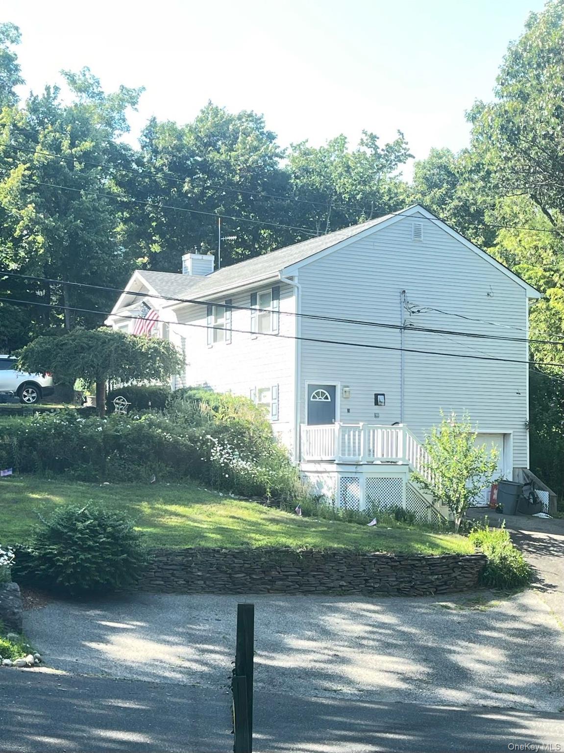 60 Aloma Road Rocky Point, NY 11778 - Photo 2 of 34 View of home's exterior featuring driveway and a garage