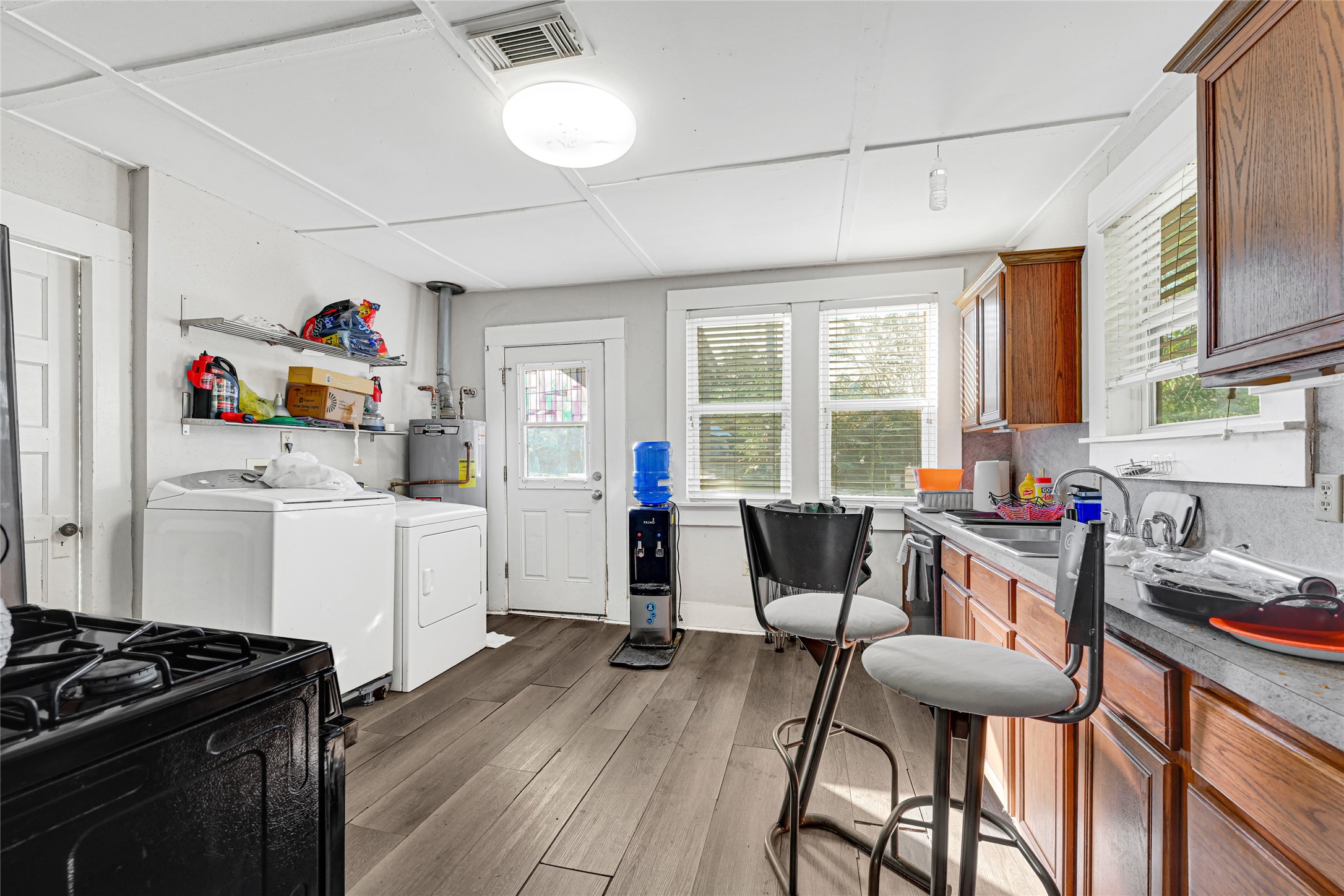 102 4th Street Sugar Land, TX 77498 - Photo 19 of 50 a kitchen that has a table chairs in it and wooden floor