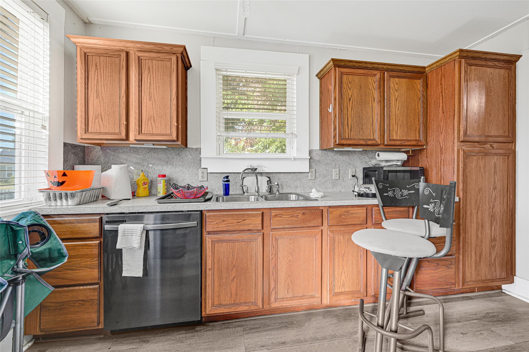 102 4th Street Sugar Land, TX 77498 - Photo 20 of 50 a kitchen with stainless steel appliances granite countertop a stove a sink dishwasher and cabinets with wooden floor