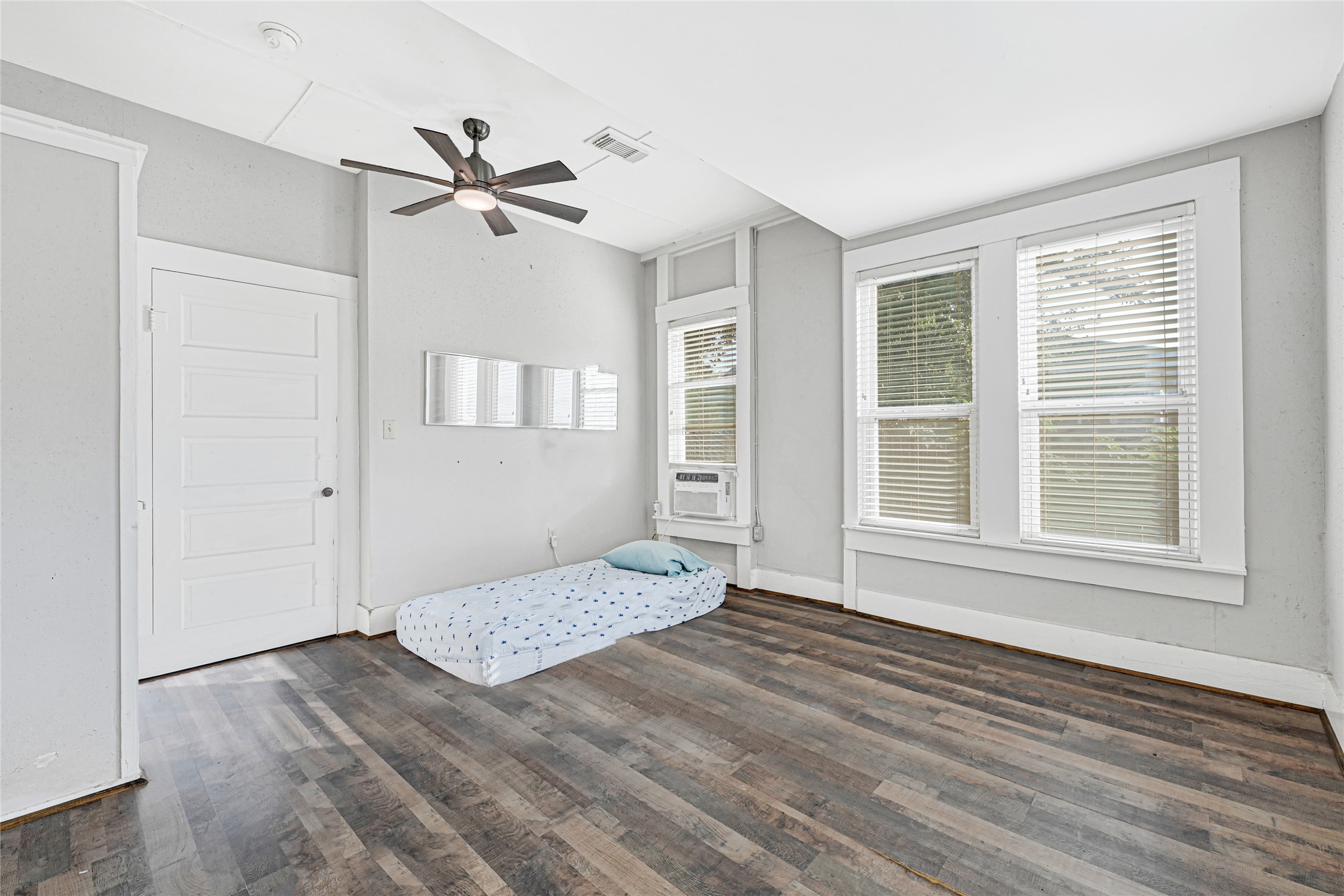 102 4th Street Sugar Land, TX 77498 - Photo 24 of 50 a view of empty room with wooden floor and fan