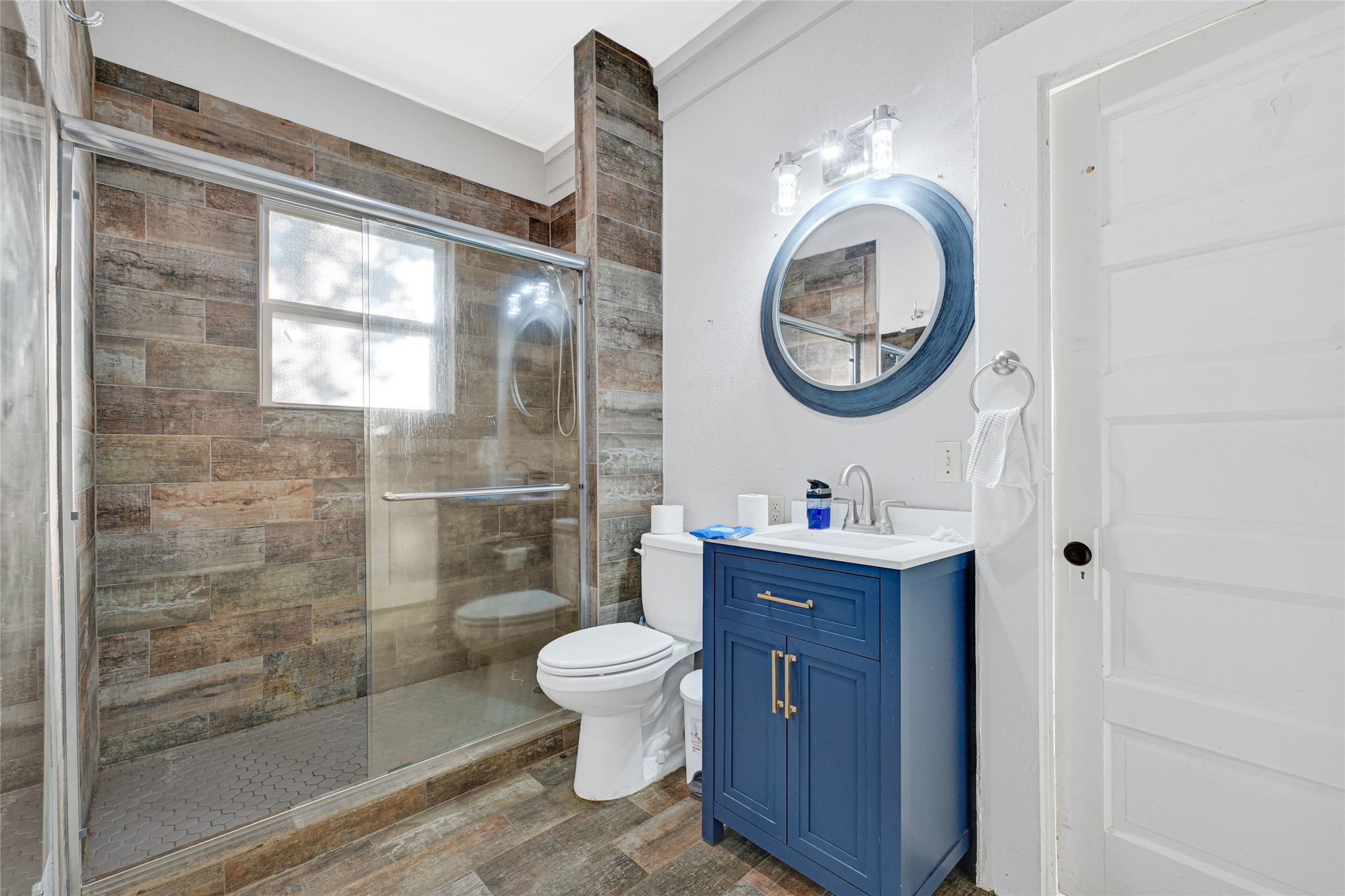 102 4th Street Sugar Land, TX 77498 - Photo 4 of 50 a bathroom with a toilet a sink and a mirror