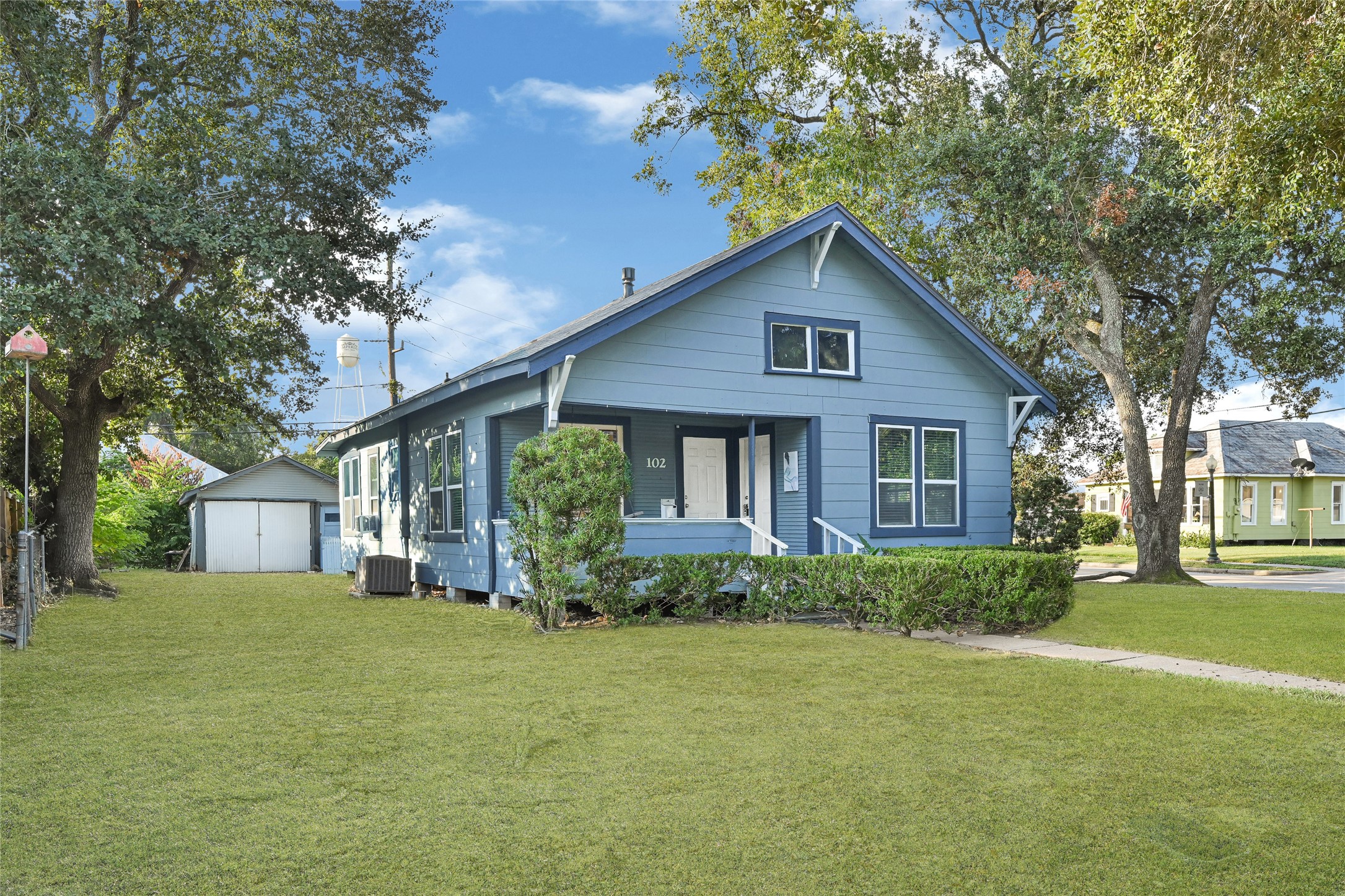 102 4th Street Sugar Land, TX 77498 - Photo 49 of 50 a front view of house with yard and trees