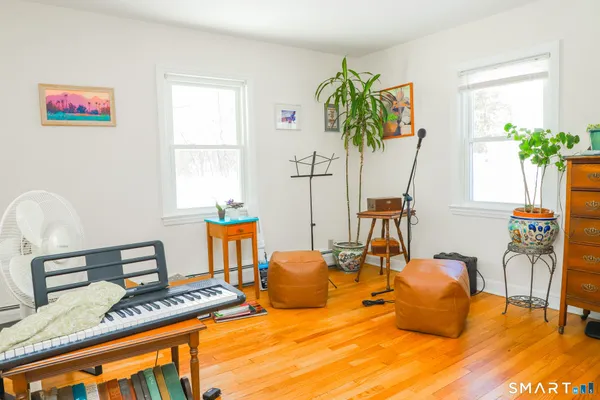 a bedroom with furniture and a potted plant