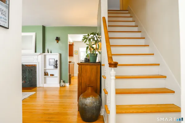 a view of entryway and hall with wooden floor