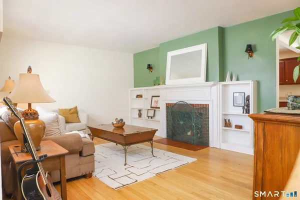a living room with furniture a fireplace and a flat screen tv